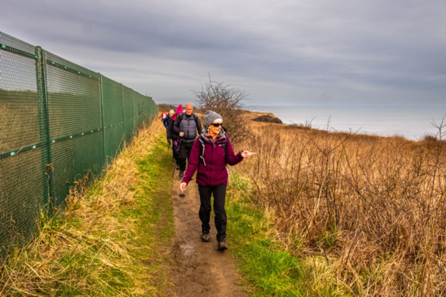 Ann leads the way along the cliff top