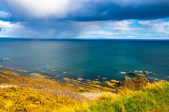 Our lunch-stop at Catcairn Bushes with rain over the sea Our lunch-stop at Catcairn Bushes with rain over the sea
