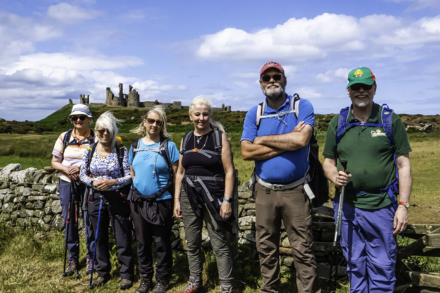 Group in front of Dunstanburgh Castle